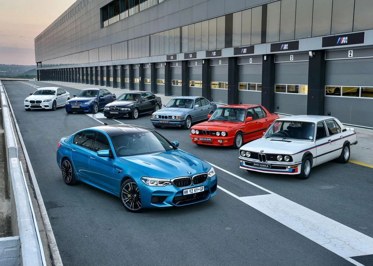 Bmw Racing Team Cars on Track at Full Throttle Wallpaper
