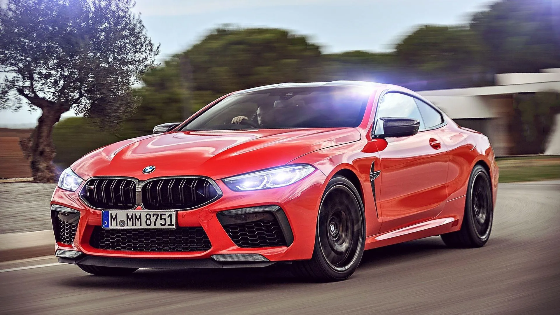 Bmw Red Coupe Driving on Road with Trees in Background