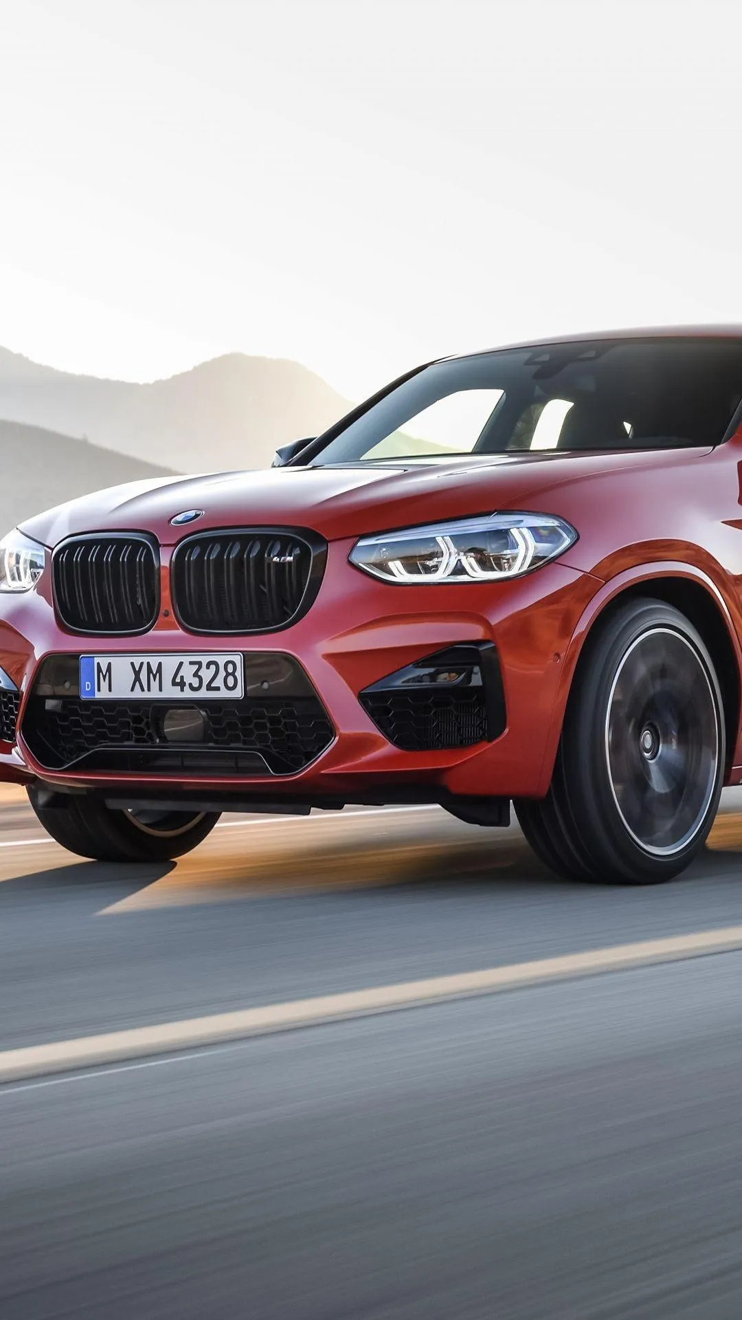Bmw Red Suv Driving Fast on Mountain Road During Day