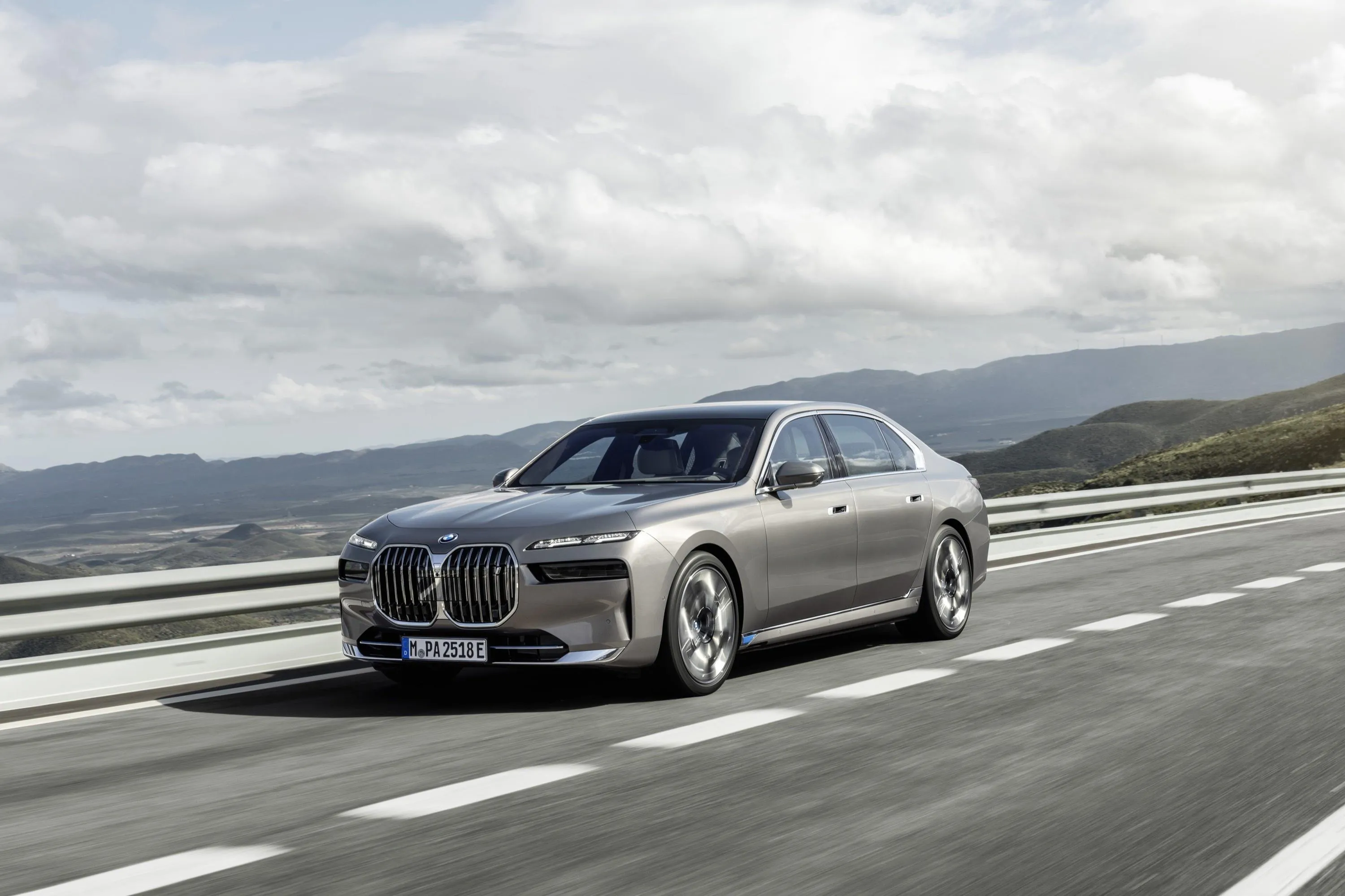 Bmw Sedan Cruising on Highway with Cloudy Skies Above