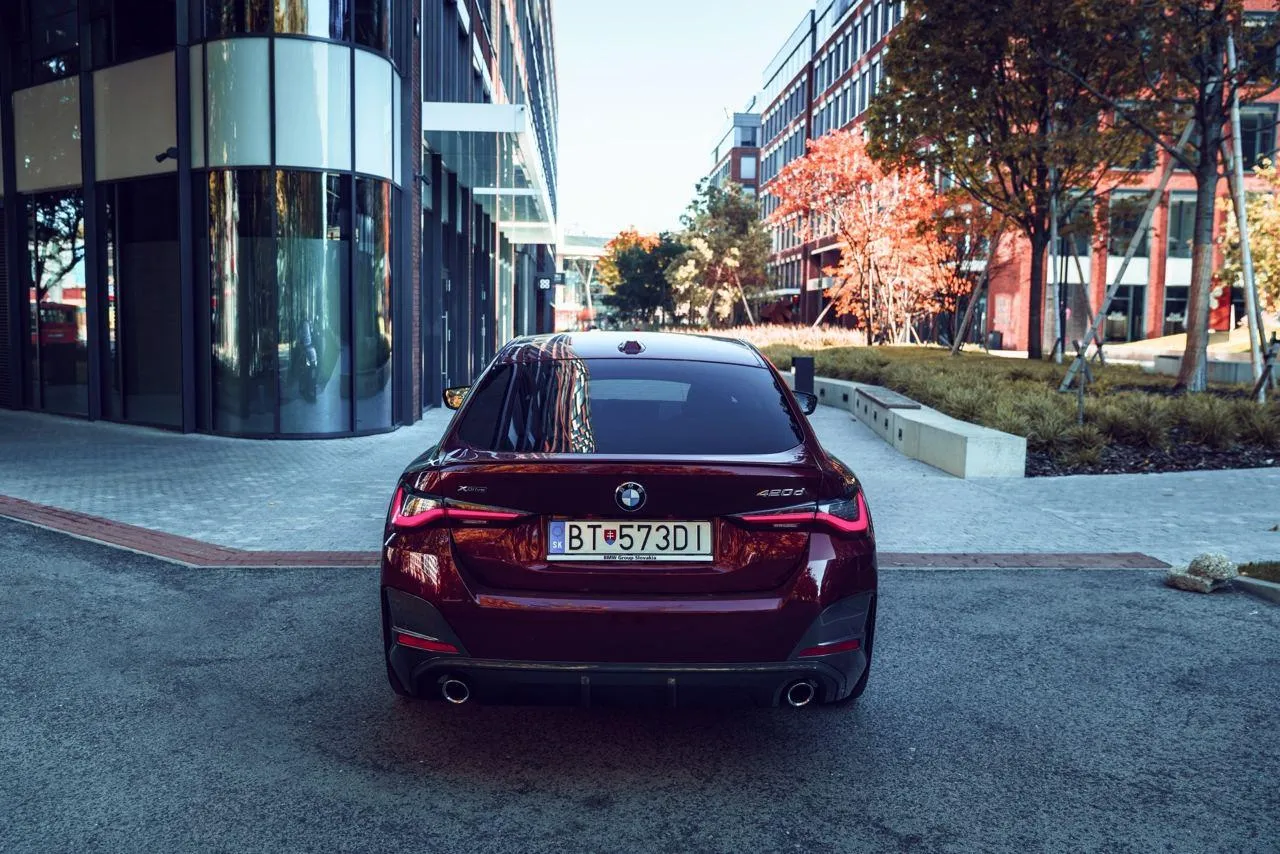 Bmw Sedan Driving in City Street During Autumn Time
