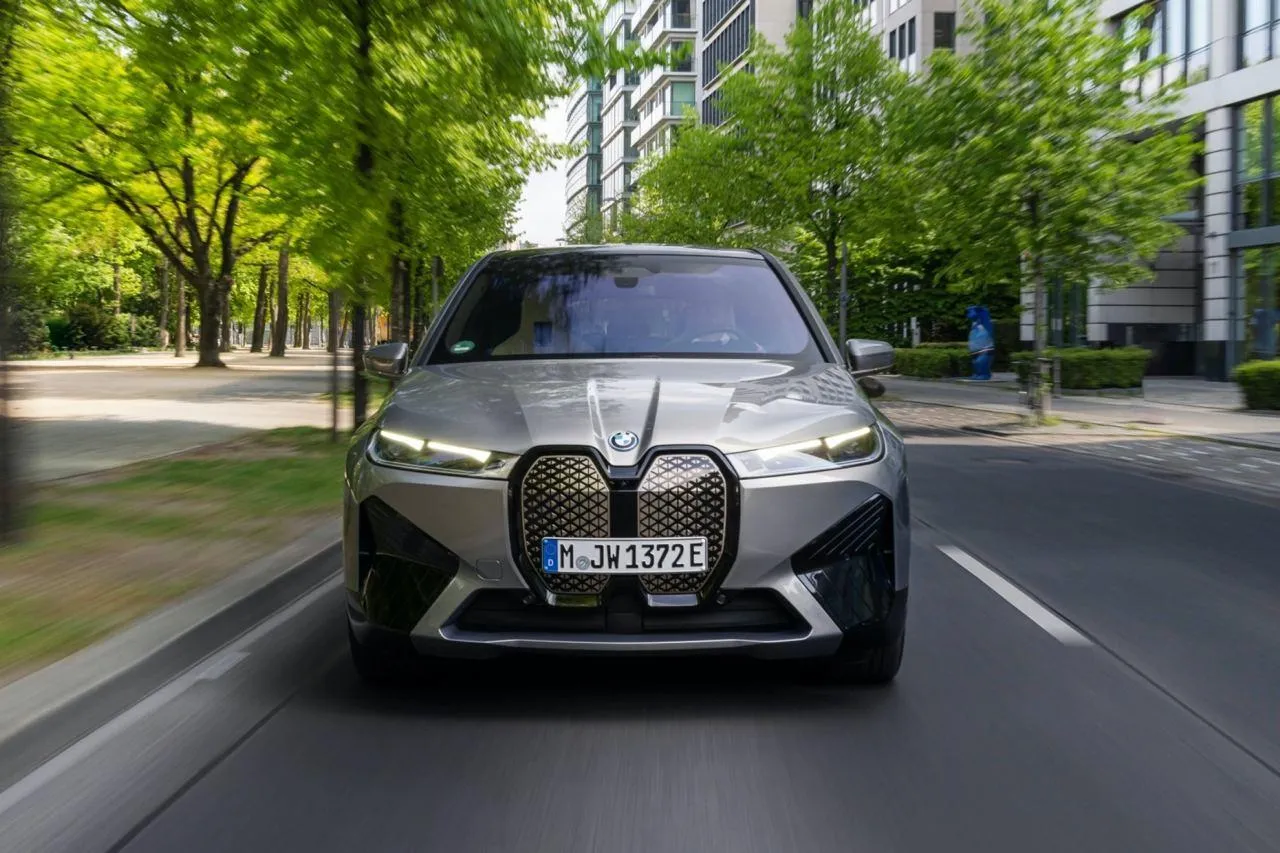 Bmw Sedan Driving on City Road Surrounded By Greenery