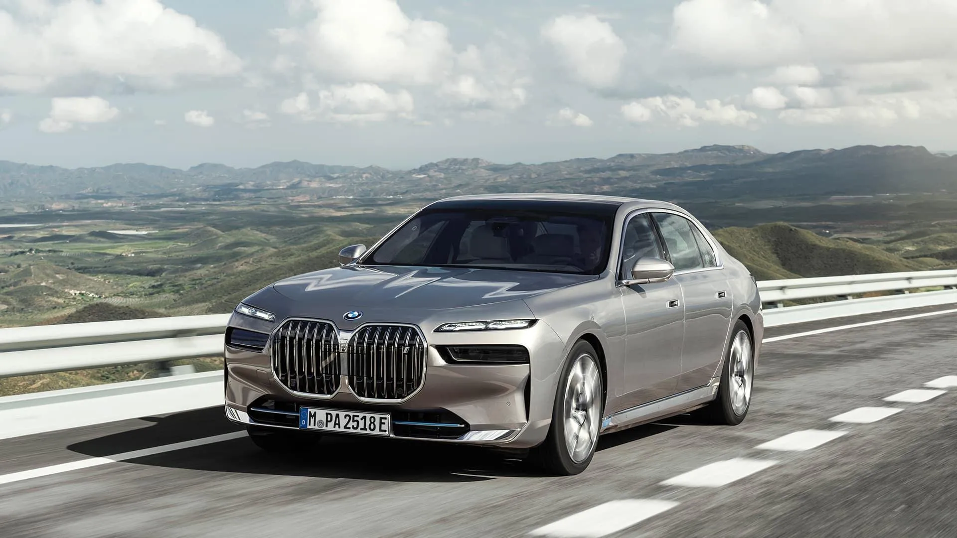Bmw Sedan Driving on Highway with Scenic Mountains