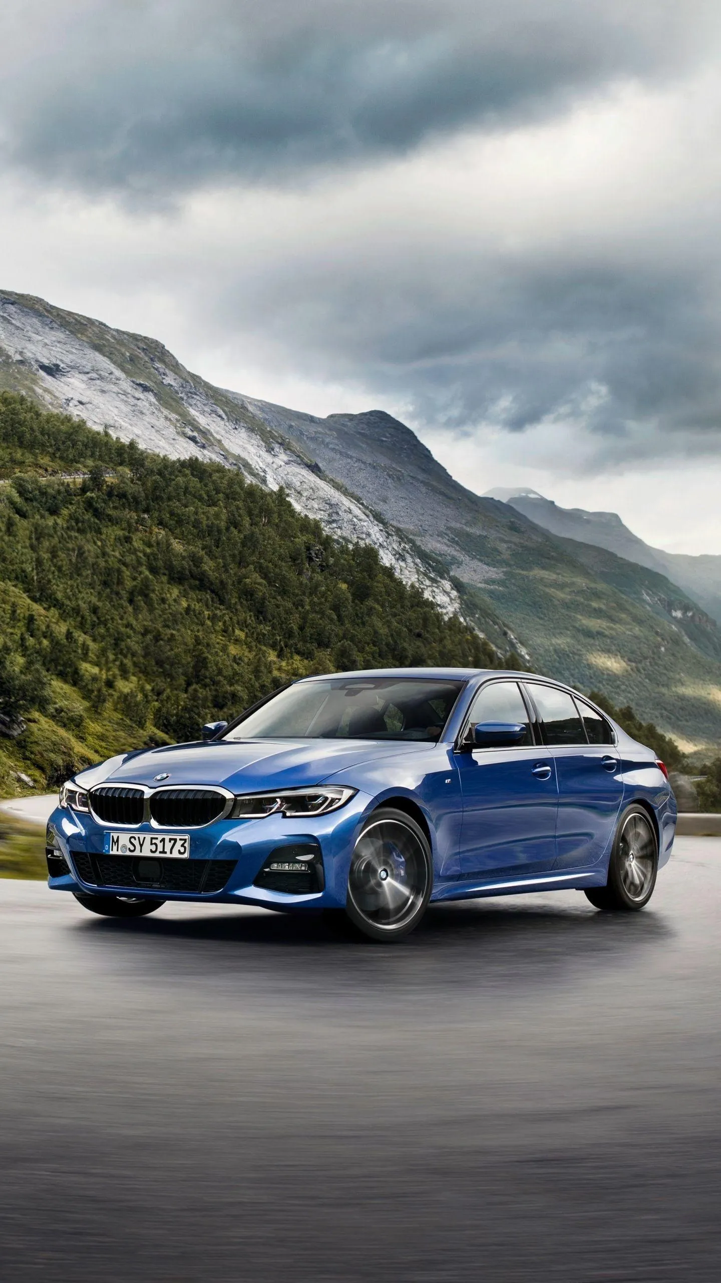 Bmw Sedan Driving on Winding Mountain Road in Daylight