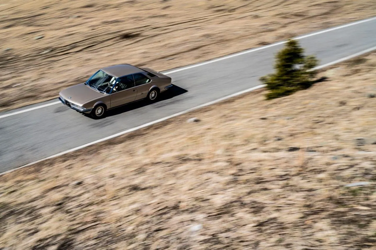 Bmw Sedan Driving on Winding Mountain Road with Skies
