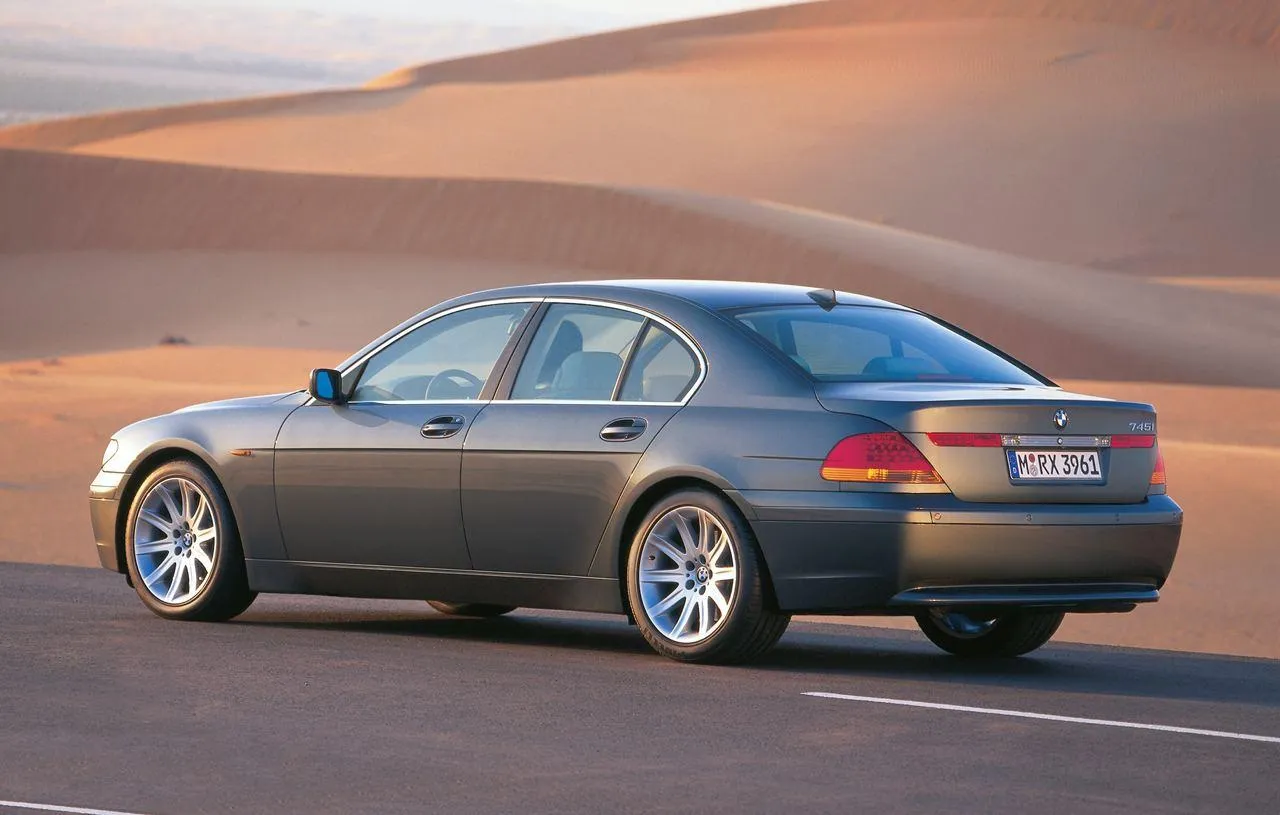 Bmw Sedan Driving Through Desert on a Sunny Day Image
