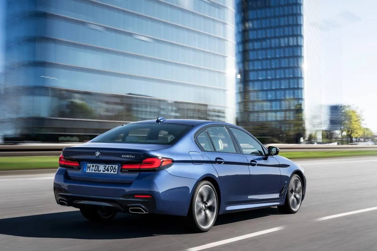 Bmw Sedan Driving Through Urban Streets Near Buildings