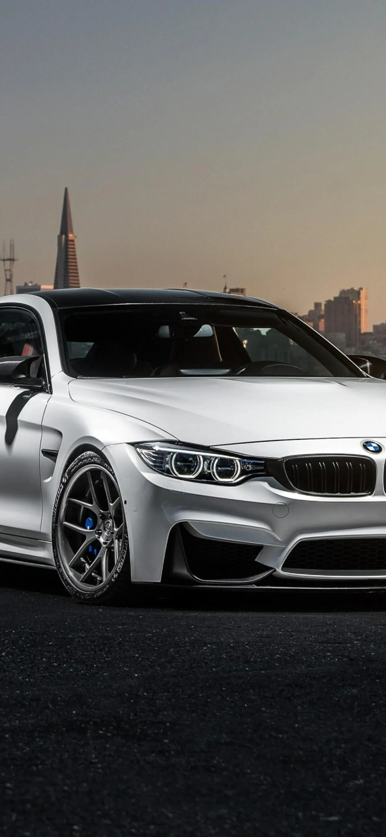 Bmw Sedan Model Parked in Front of a Scenic City Skyline