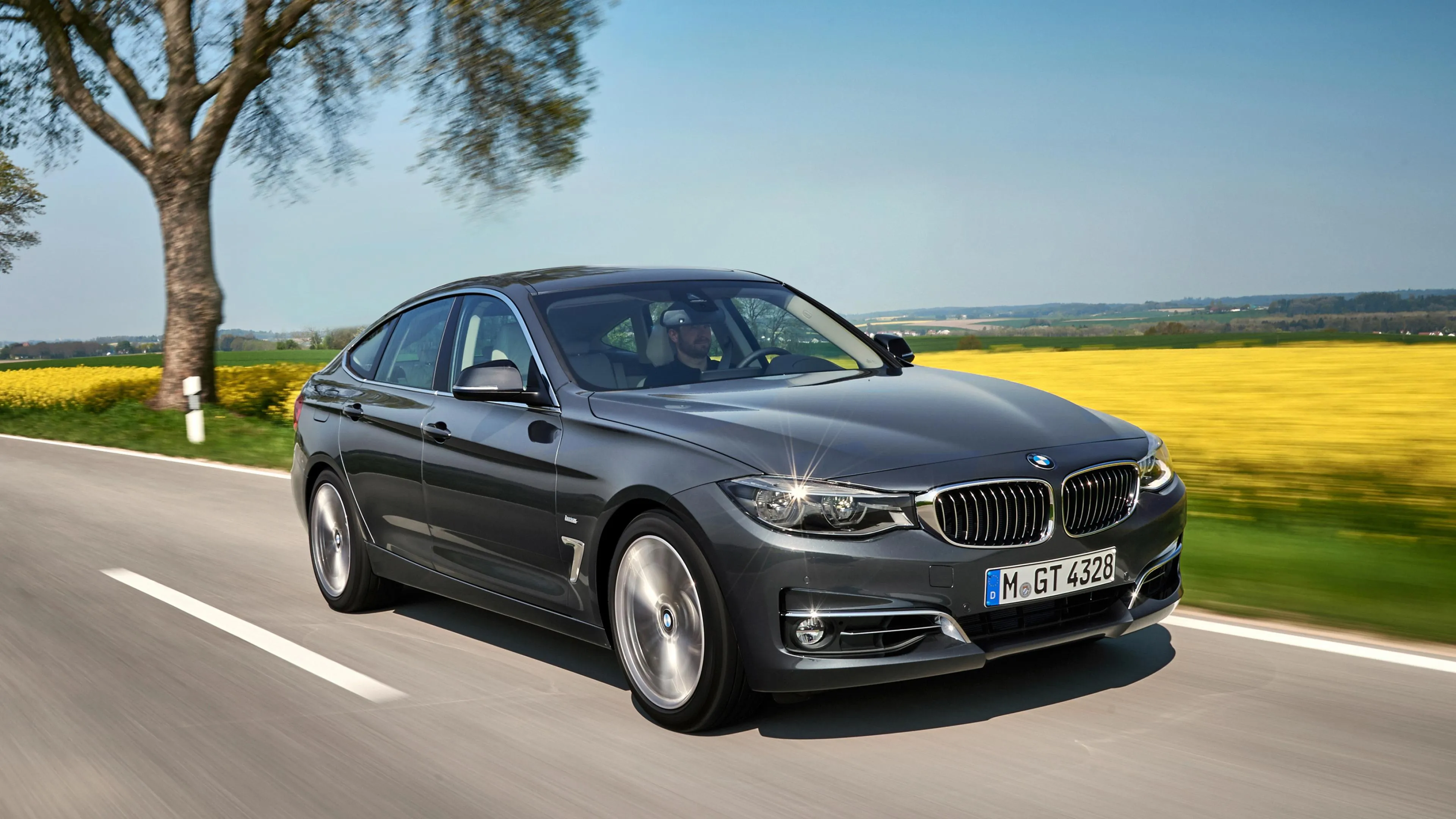 Bmw Sedan Parked By the Lake on a Sunny Day Free Wallpaper