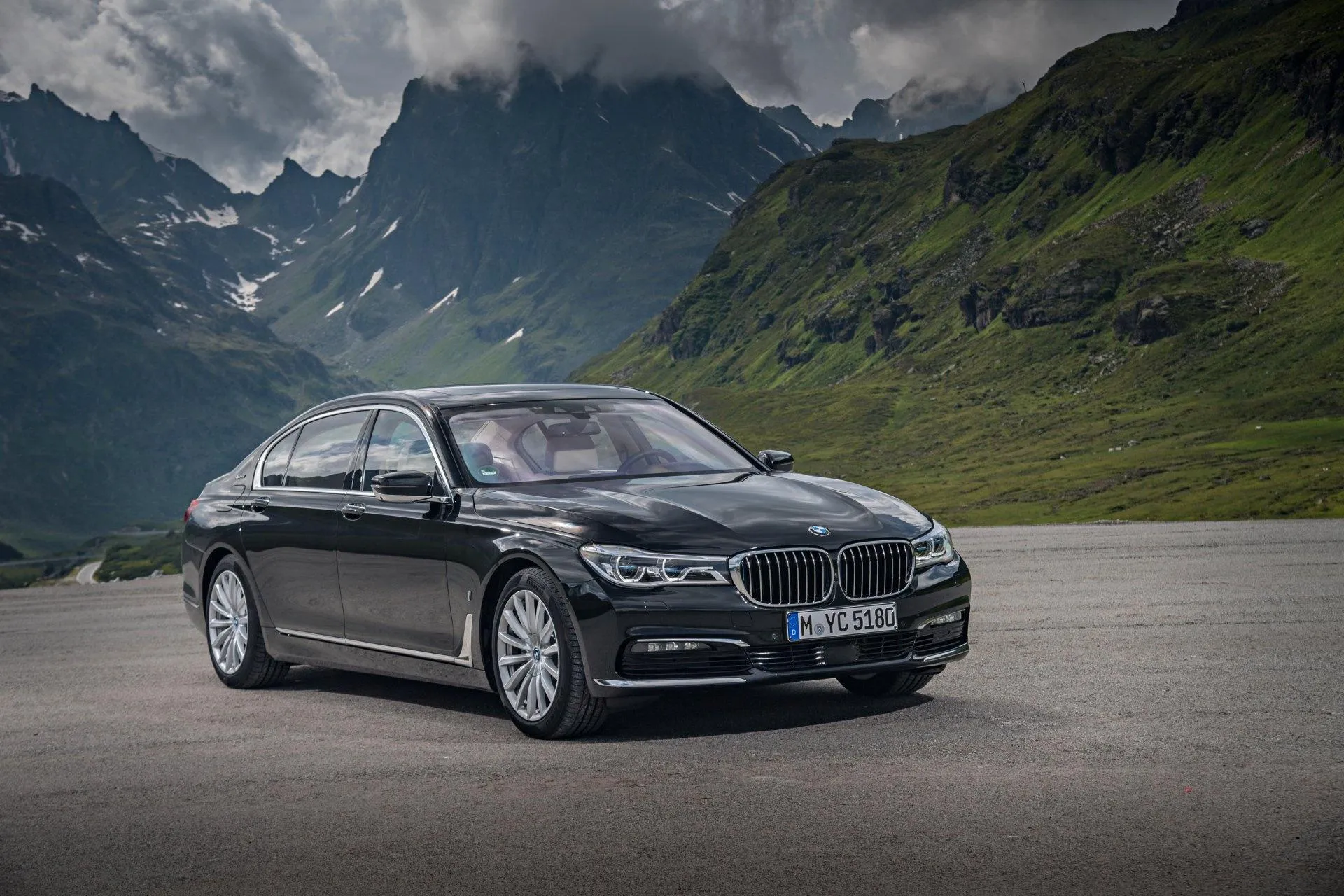 Bmw Sedan Parked in Scenic Valley Surrounded By Mountains