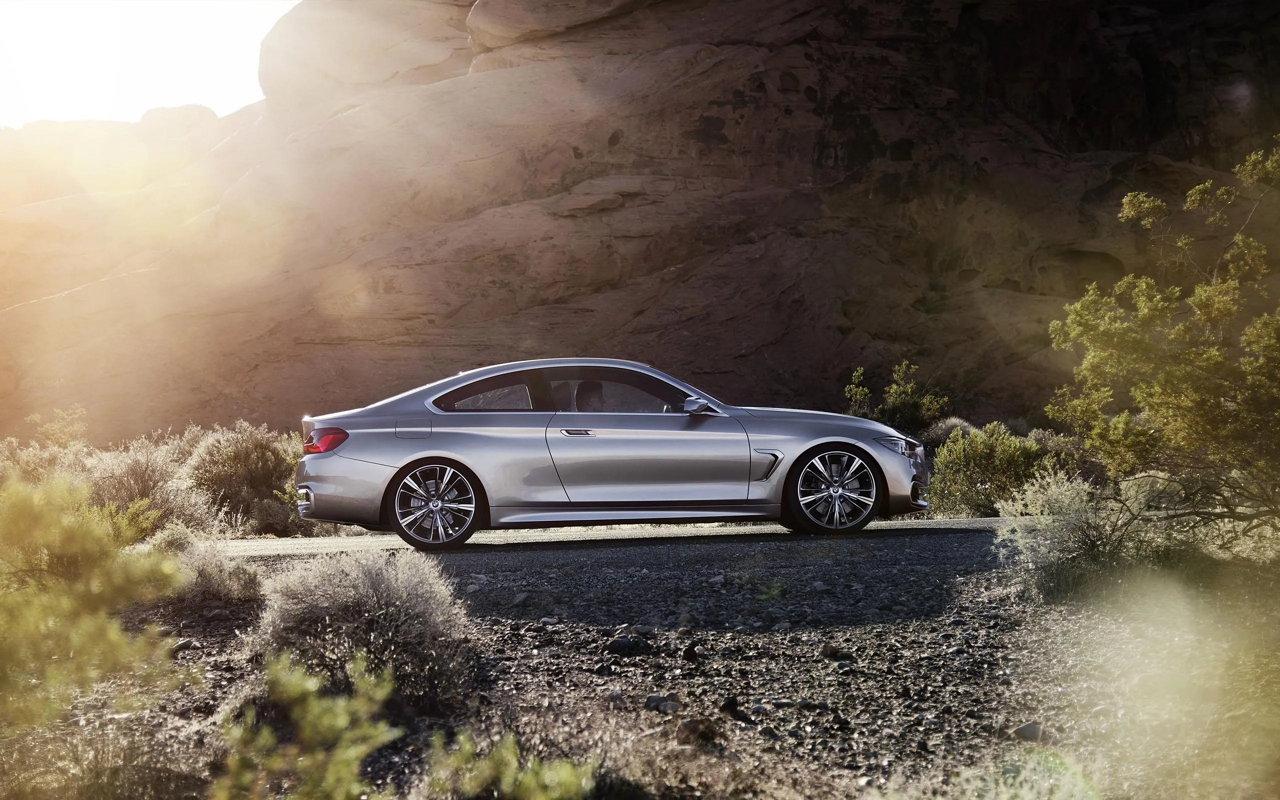 Bmw Sedan Parked on a Grassy Hill at Sunrise Free Wallpaper