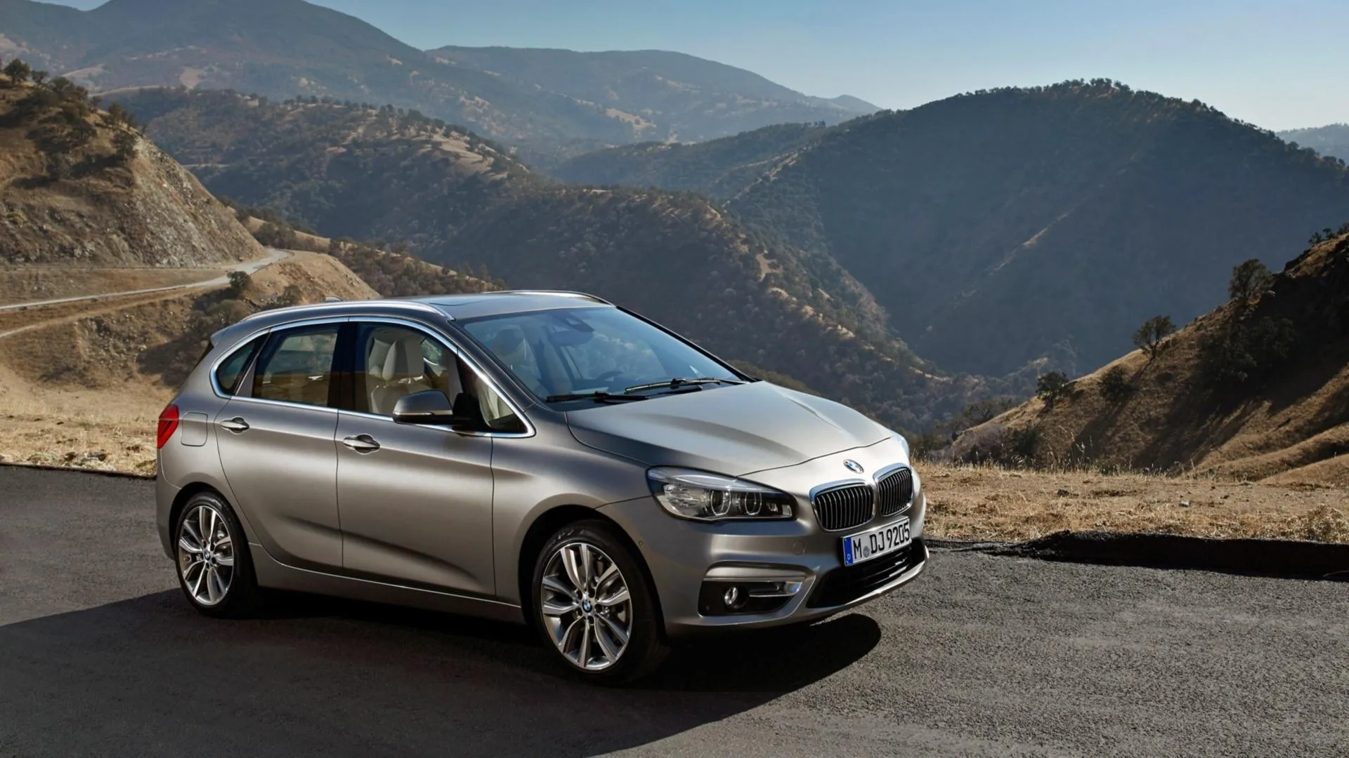Bmw Sedan Parked on Hilltop Road with Mountain View