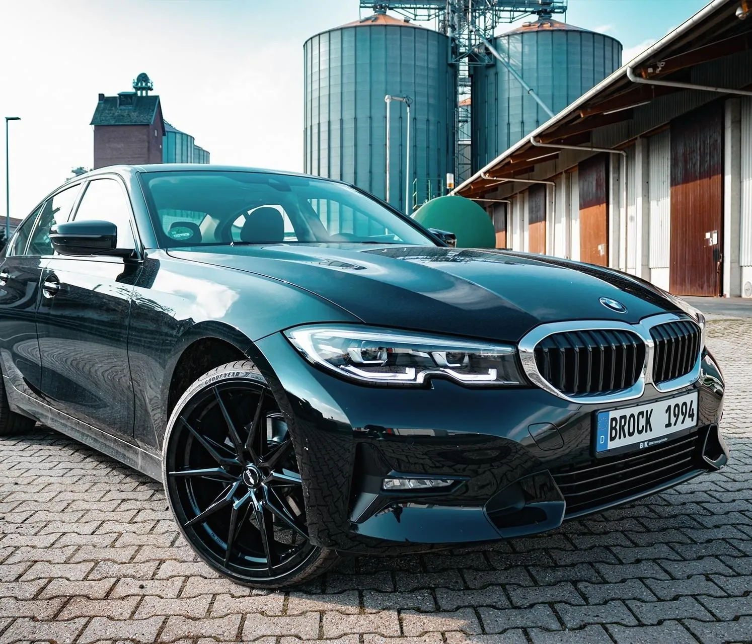 Bmw Sedan Parked with Industrial Background View Wallpaper