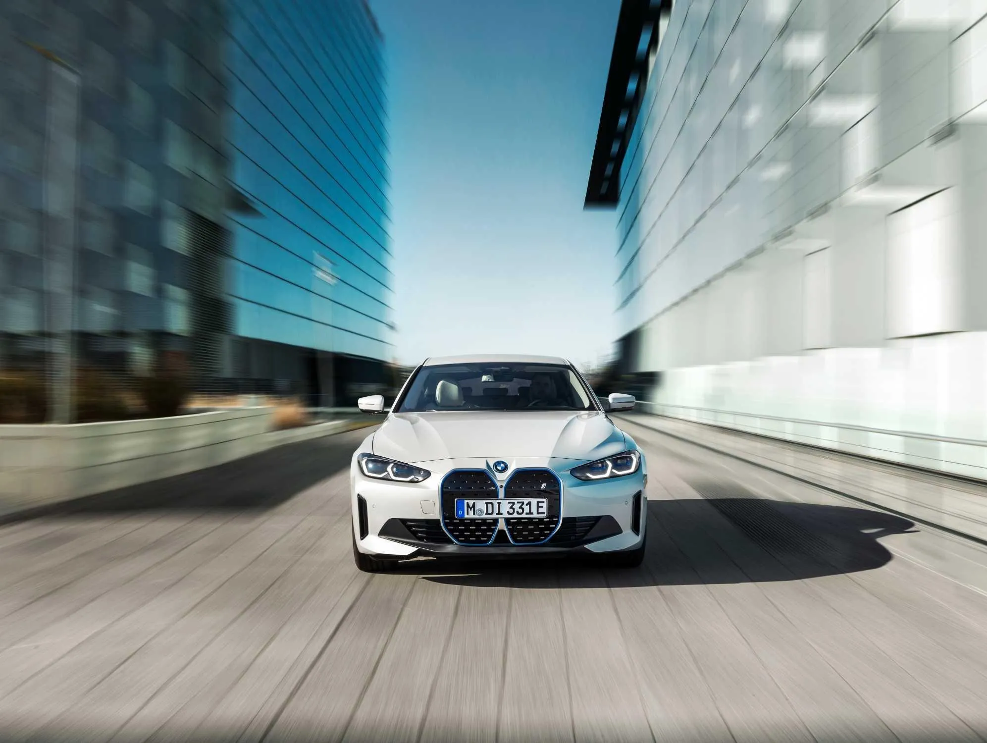 Bmw Sedan with a Clear View of Its Front Grille on the Road