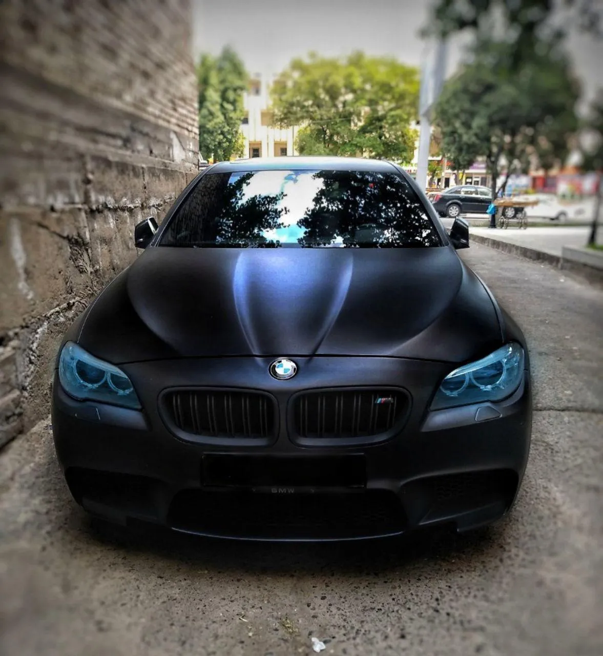 Bmw Sedan with Aggressive Styling Parked in a City Setting