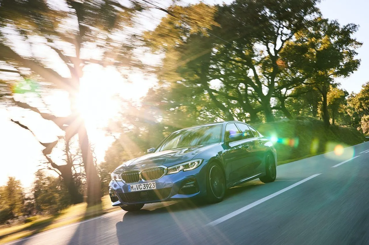 Bmw Sedan with Sunlight and Scenic Background Wallpaper