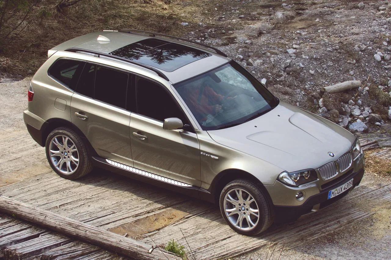 Bmw Silver Suv Driving on Rough Terrain with Scenic Backdrop