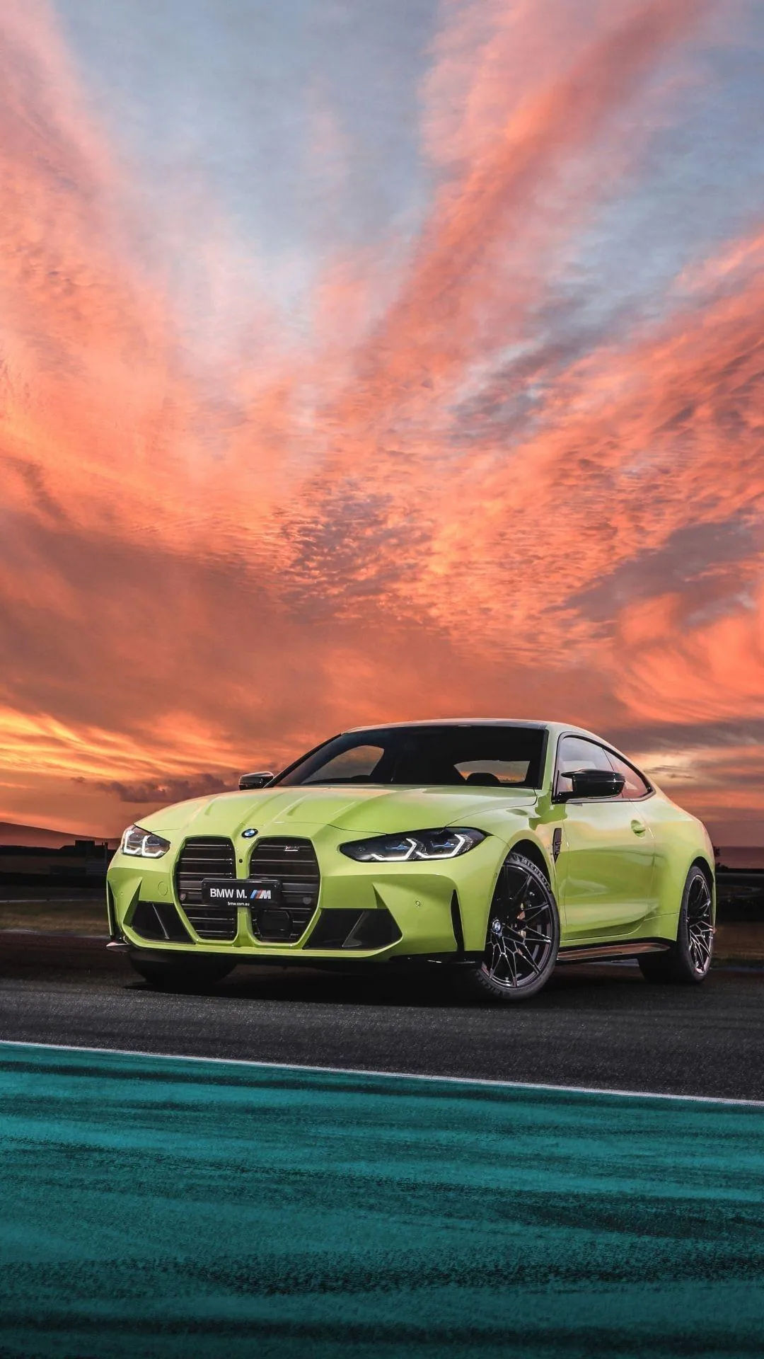 Bmw Sports Car Driving on Beach with Sunset Background