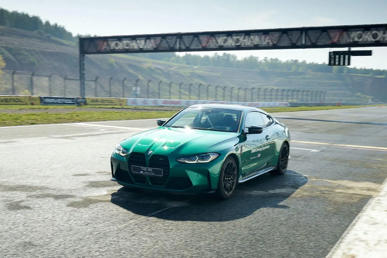 Bmw Sports Car on Race Track Under Clear Blue Sky Wallpaper