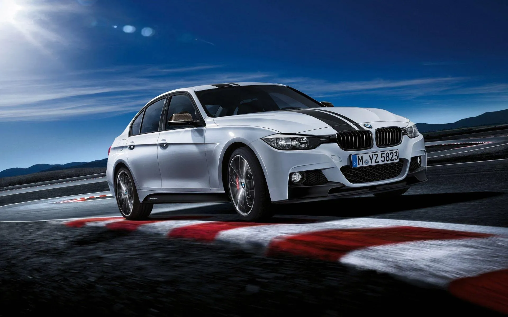 Bmw Sports Car on the Racetrack Taking Sharp Turns at Speed
