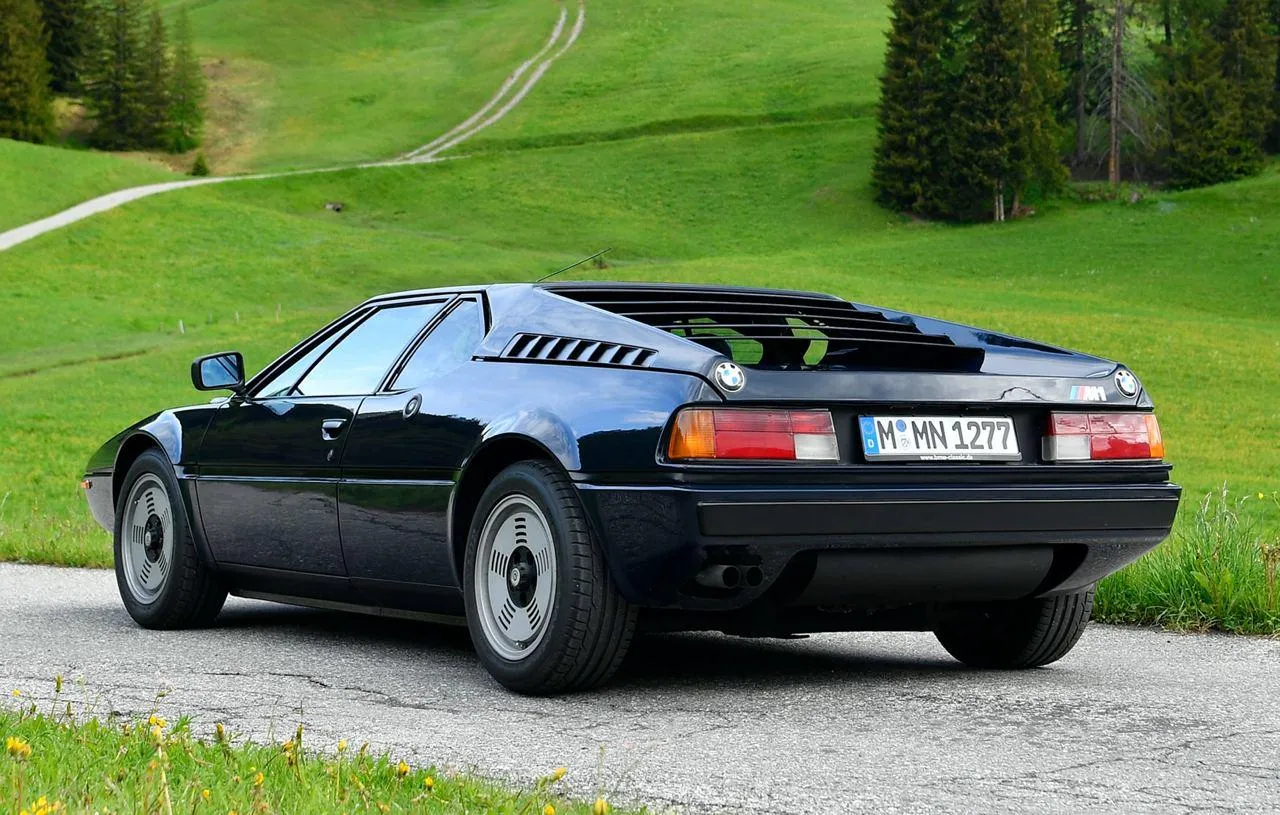 Bmw Sports Car Parked on Grass with Hills in Background