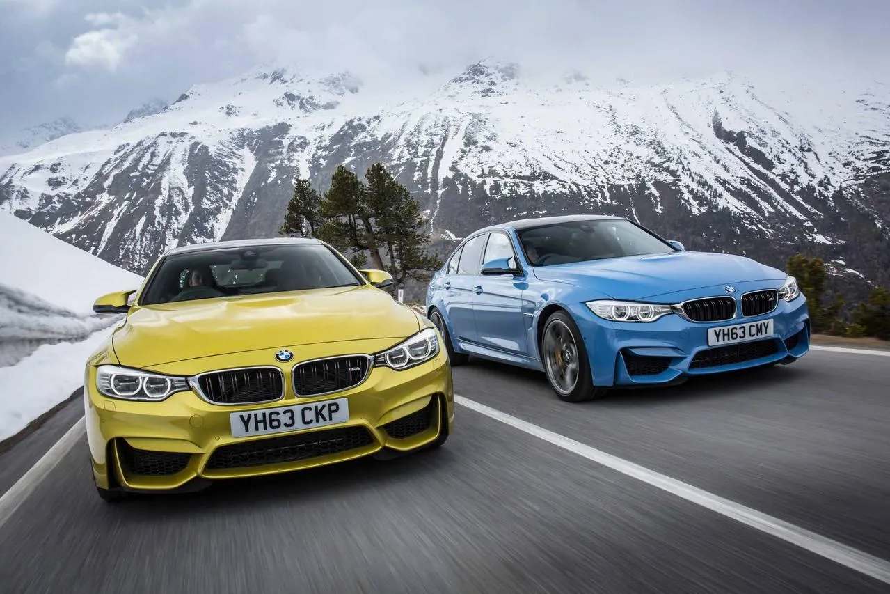 Bmw Sports Cars Driving on Snowy Mountain Pass