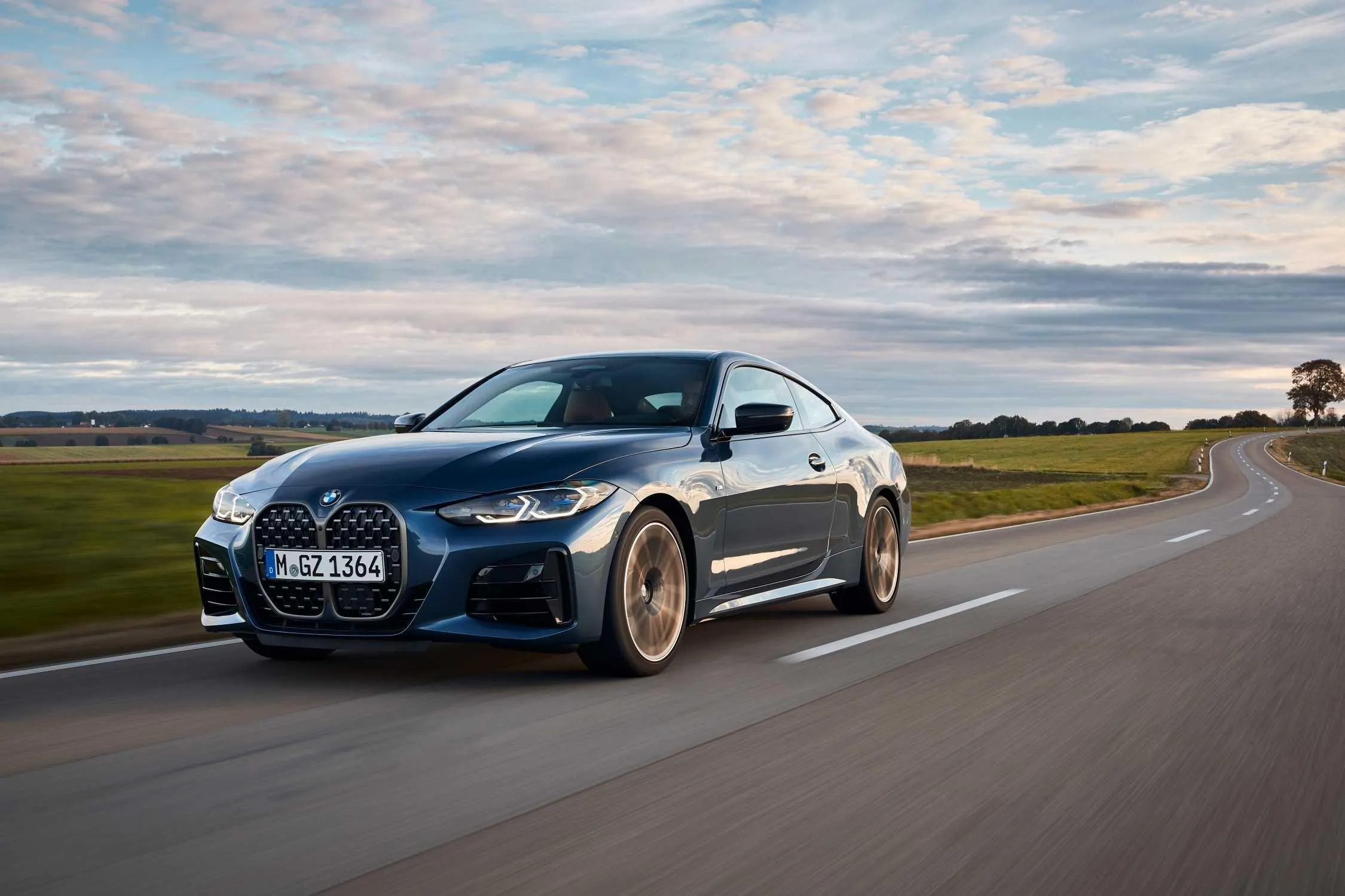 Bmw Sports Coupe on Open Road with Sky and Mountains View