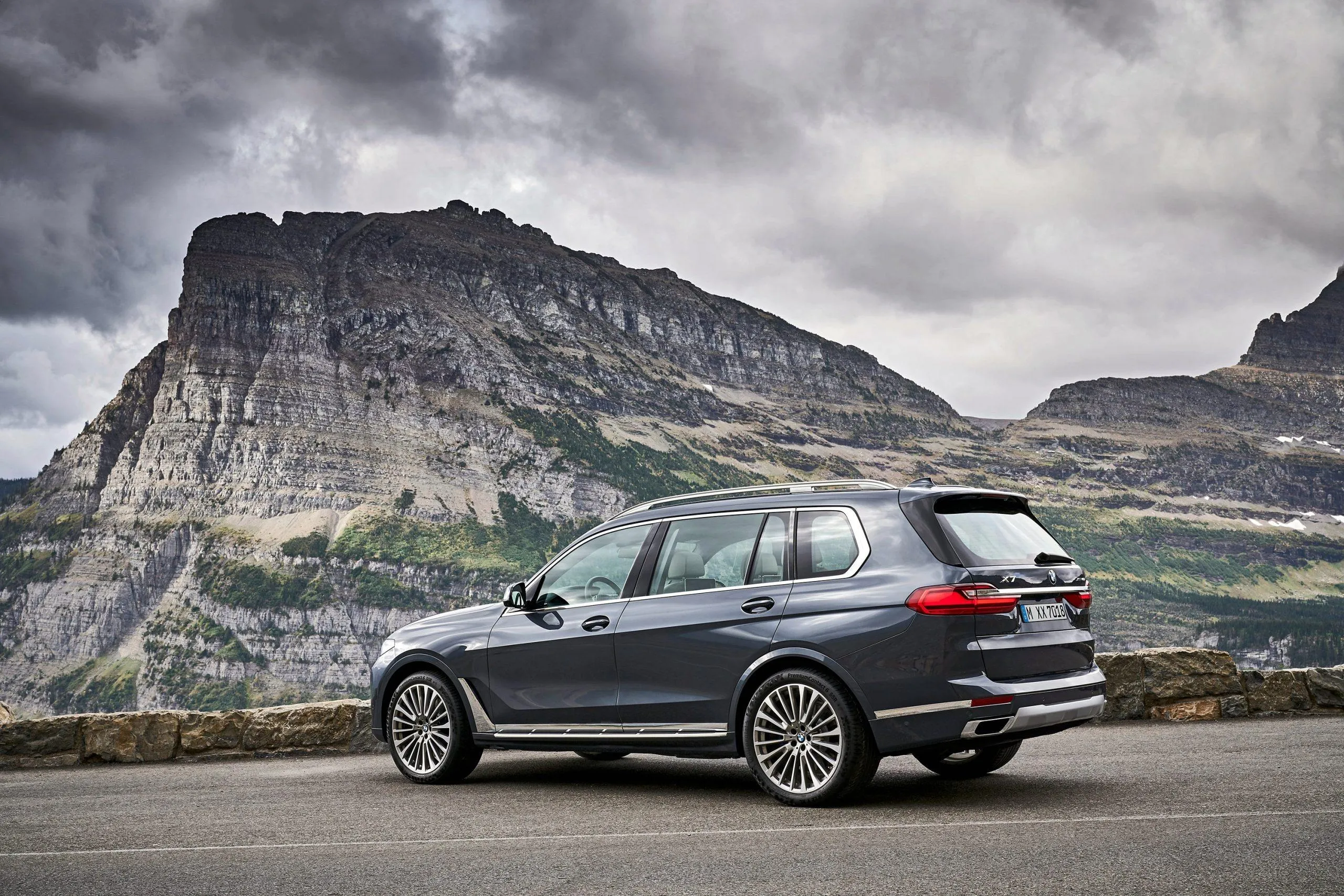 Bmw Station Wagon Parked Near Mountain Under Gray Skies
