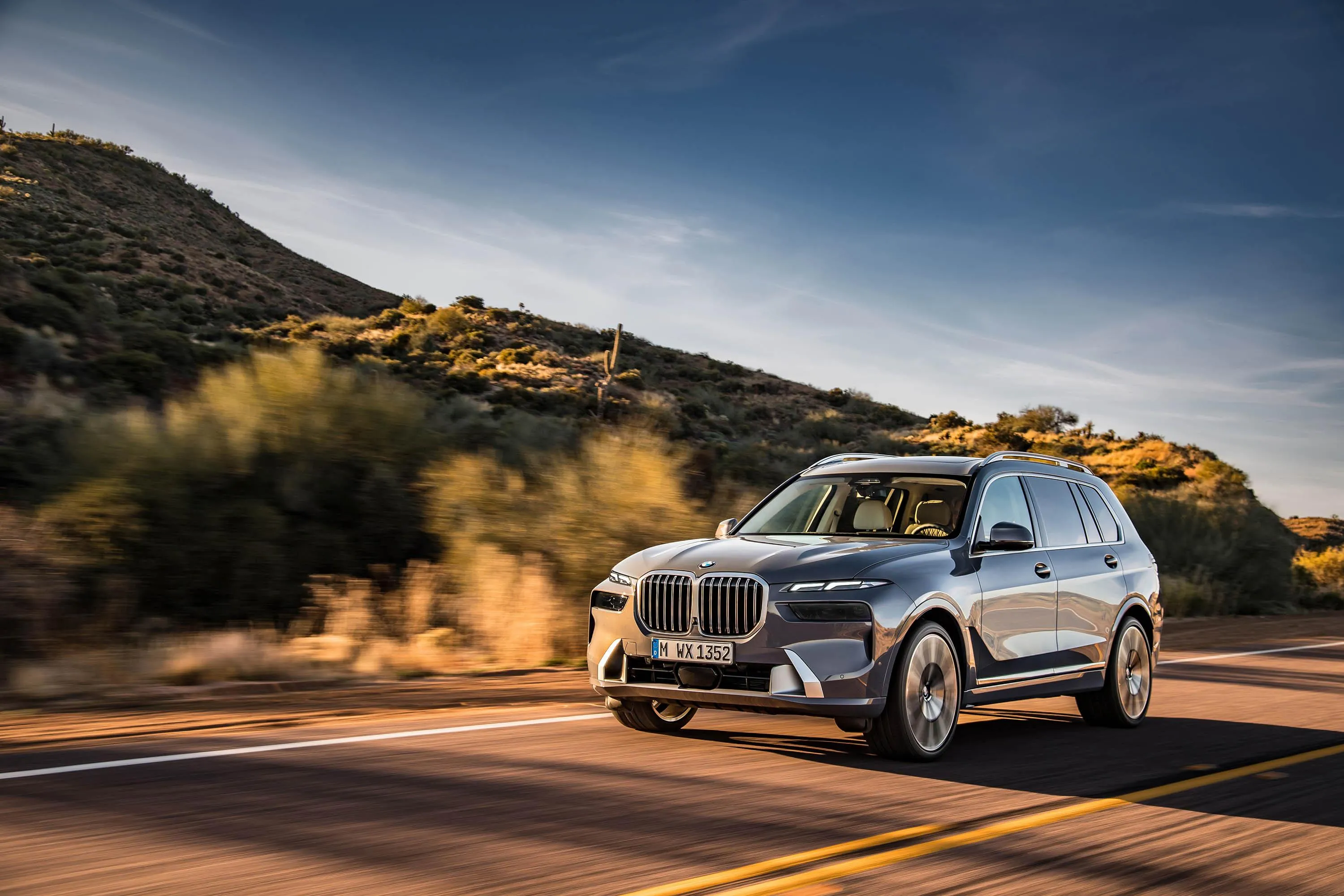 Bmw Suv Cruising on Highway Through Mountain Landscape