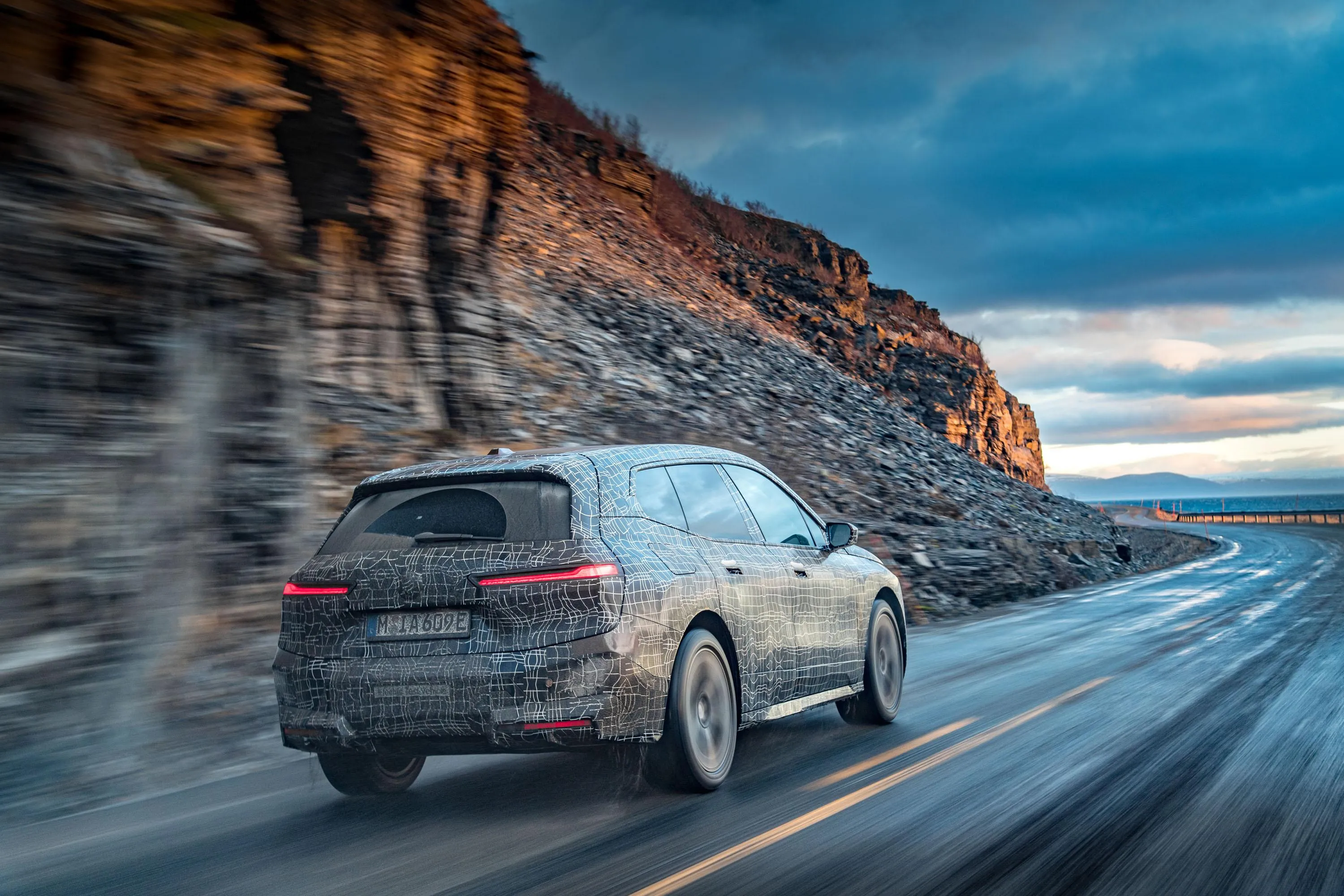 Bmw Suv Driving Fast Beside Cliff on Coastal Highway