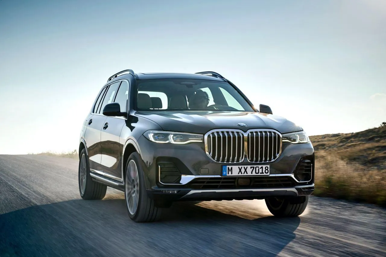 Bmw Suv Driving on Curvy Road Through Dry Mountain Terrain
