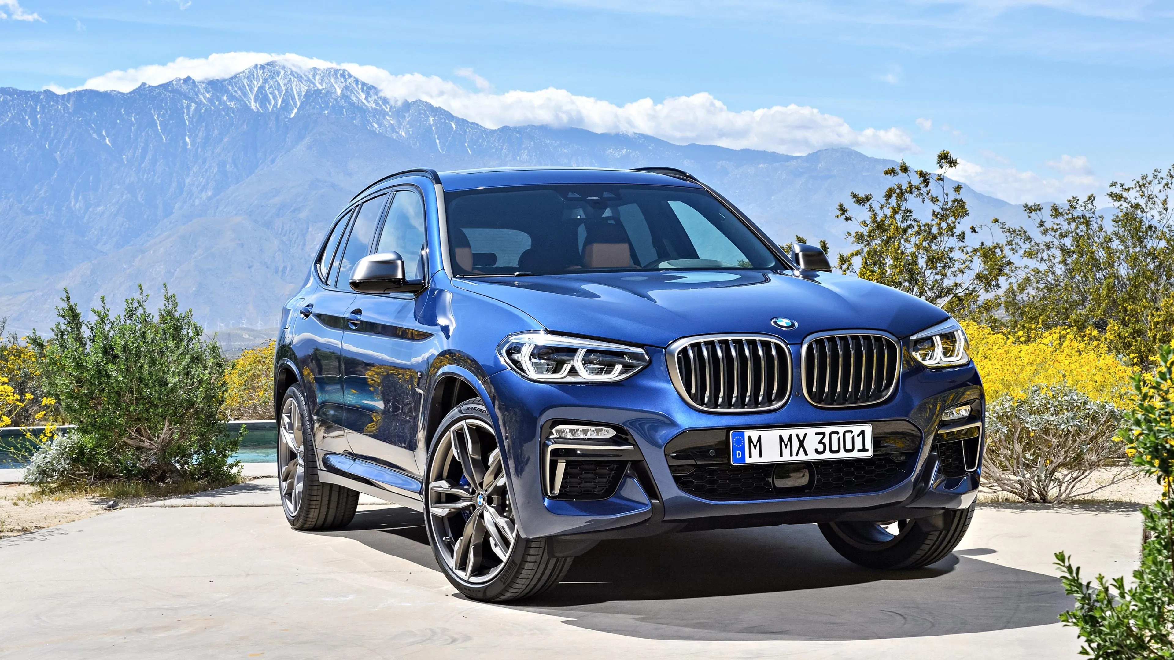 Bmw Suv Driving on Open Road with Mountain Background