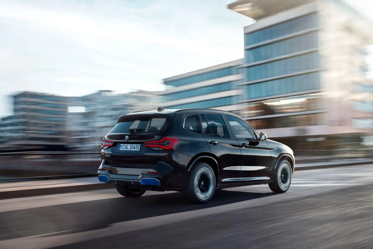 Bmw Suv Driving Through City Streets in Motion Wallpaper Hd