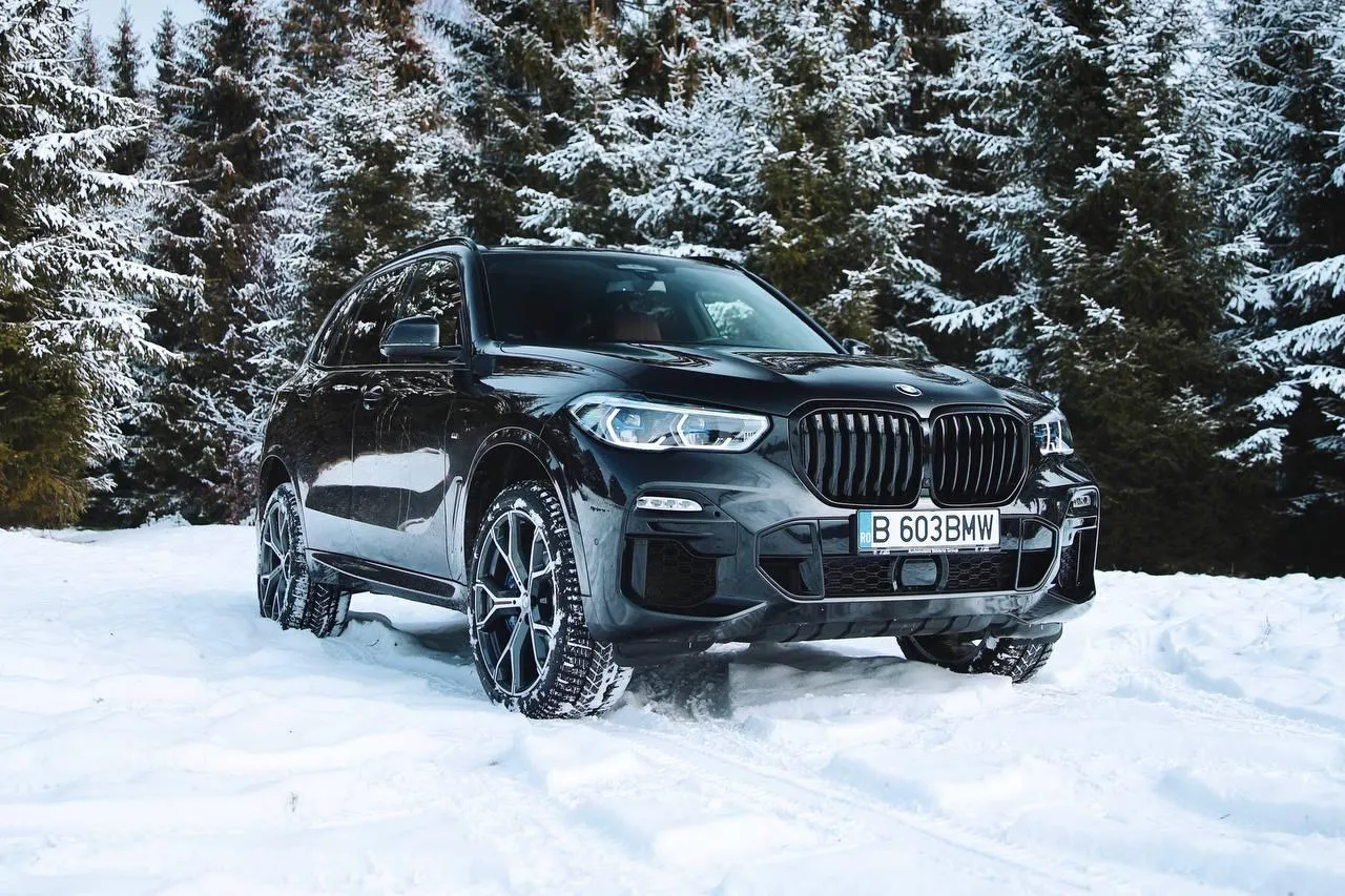 Bmw Suv Driving Through Deep Snow in Winter Forest