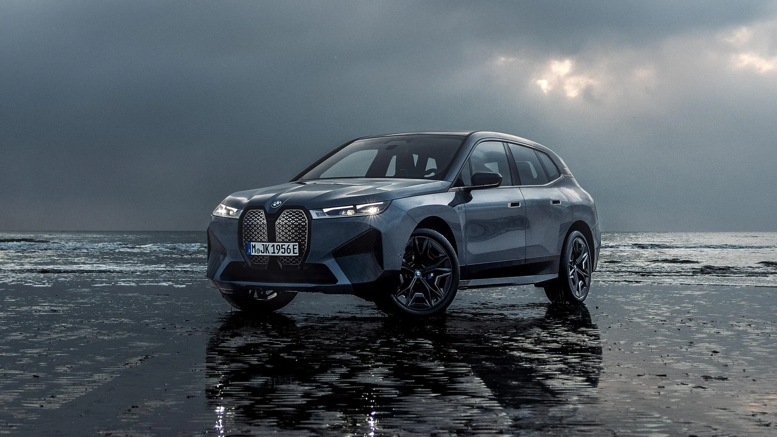 Bmw Suv Driving Through Shallow Water on Beach Image
