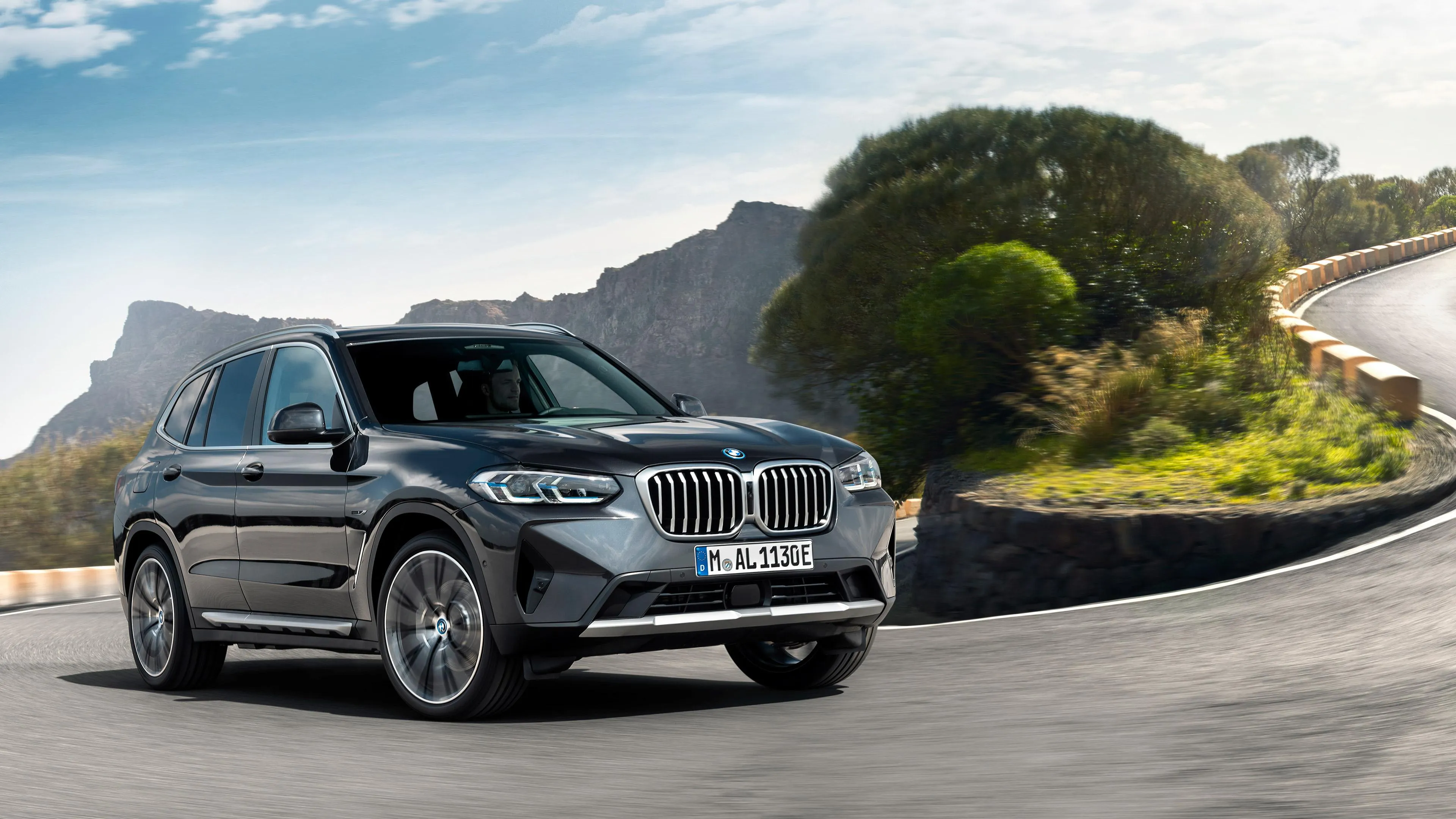 Bmw Suv Driving Uphill on Winding Scenic Mountain Road