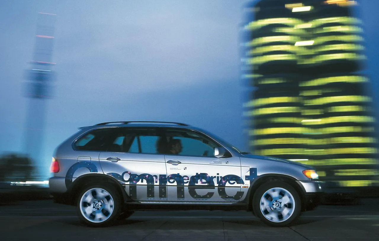 Bmw Suv in Motion with City Skyscrapers in Background