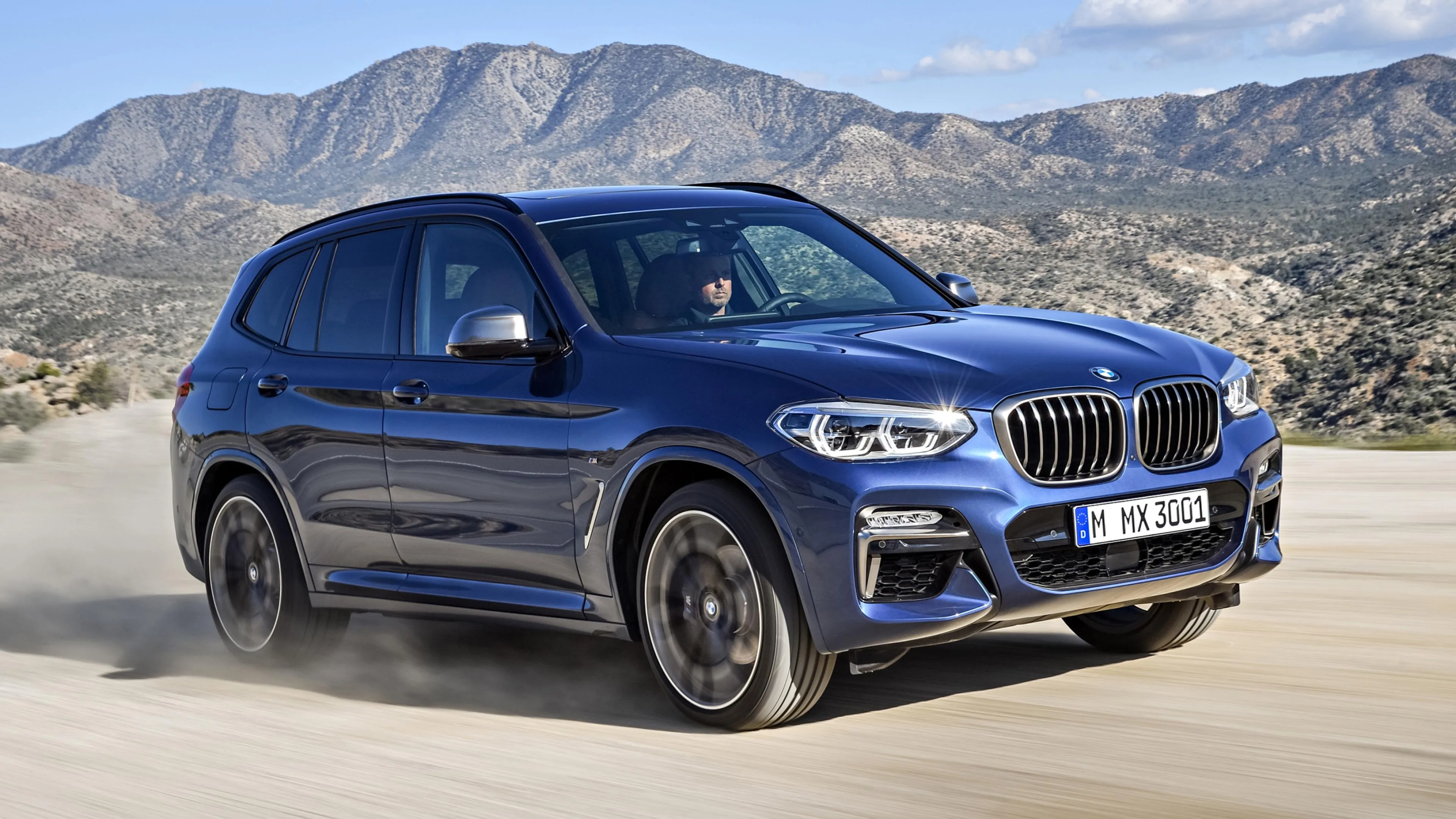 Bmw Suv Kicking Up Dust While Driving on Desert Terrain