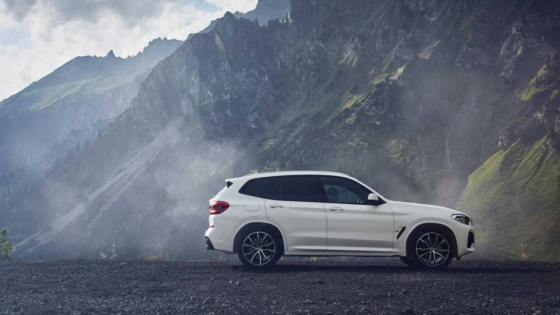 Bmw Suv Model Displayed in a Dramatic Coastal Background