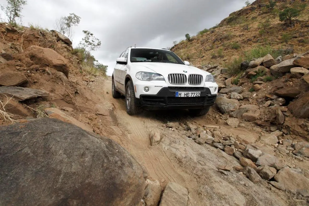 Bmw Suv Off Roading in Rocky Mountain Terrain Landscape