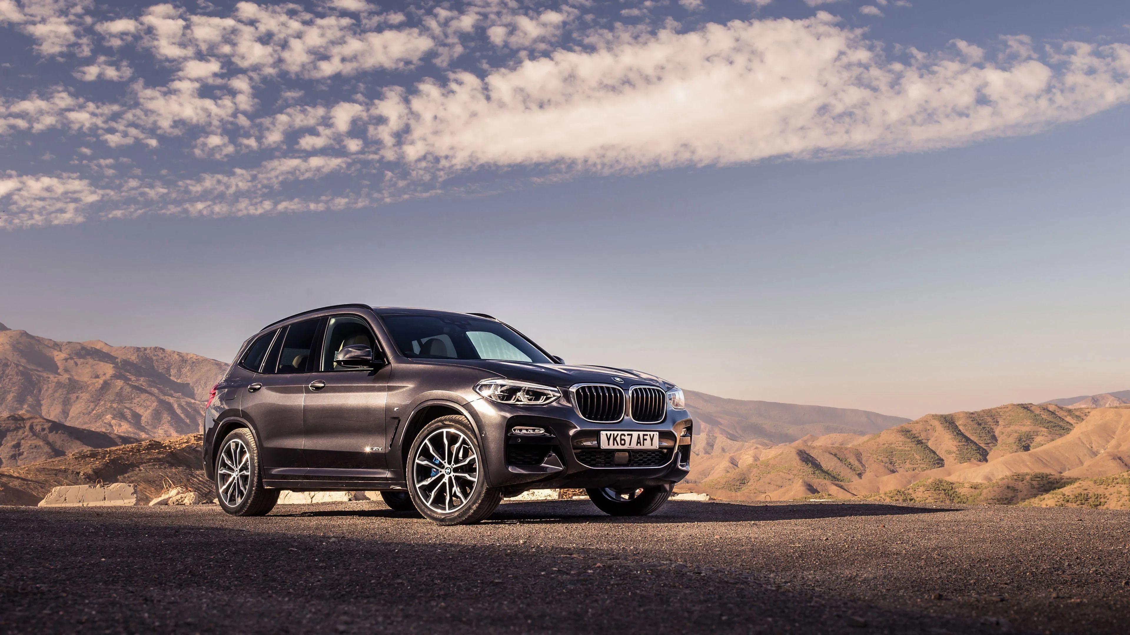Bmw Suv on Desert Terrain During Early Morning Light