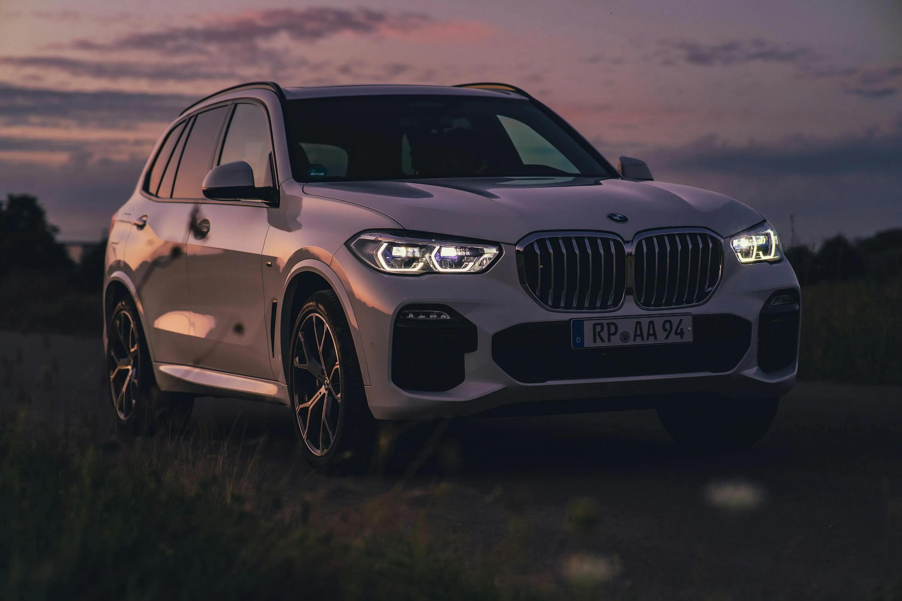 Bmw Suv Parked at Sunset Creating a Calm and Scenic Mood