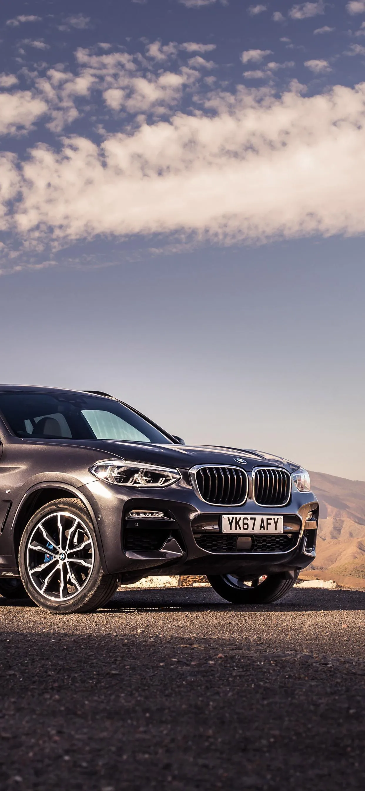 Bmw Suv Parked in Desert Setting During Golden Hour