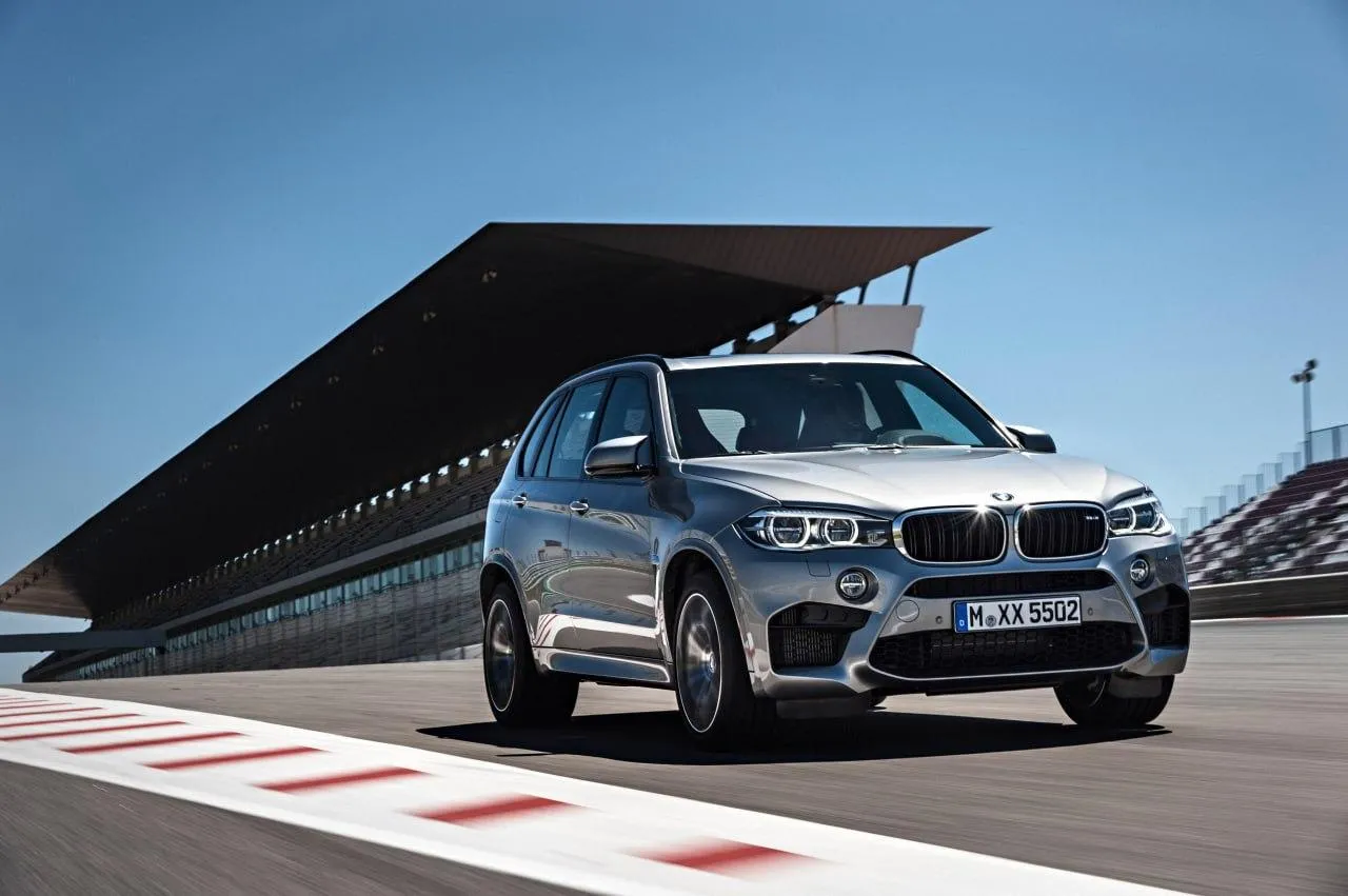Bmw Suv Positioned on a Race Track Near Grandstand Image