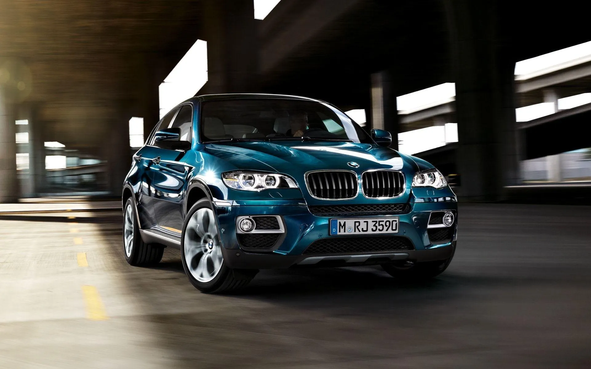 Bmw Suv Turning Inside a Parking Structure with Blur