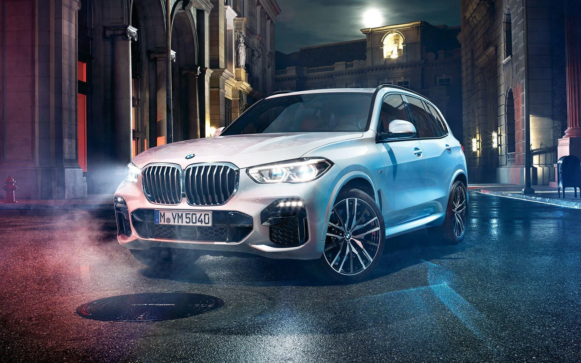 Bmw Suv Under City Lights in Modern Urban Environment