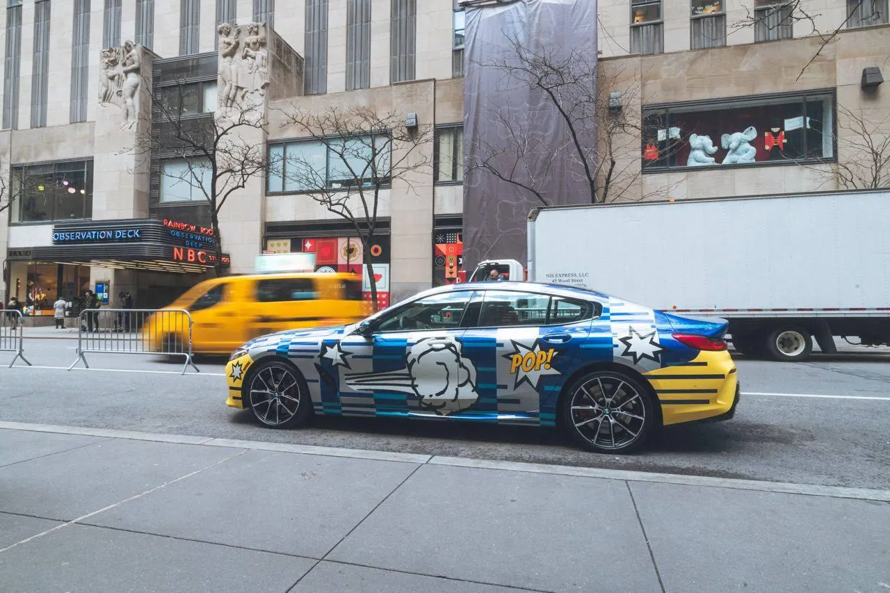 Bmw Touring Car Racing Down City Street with Traffic Around