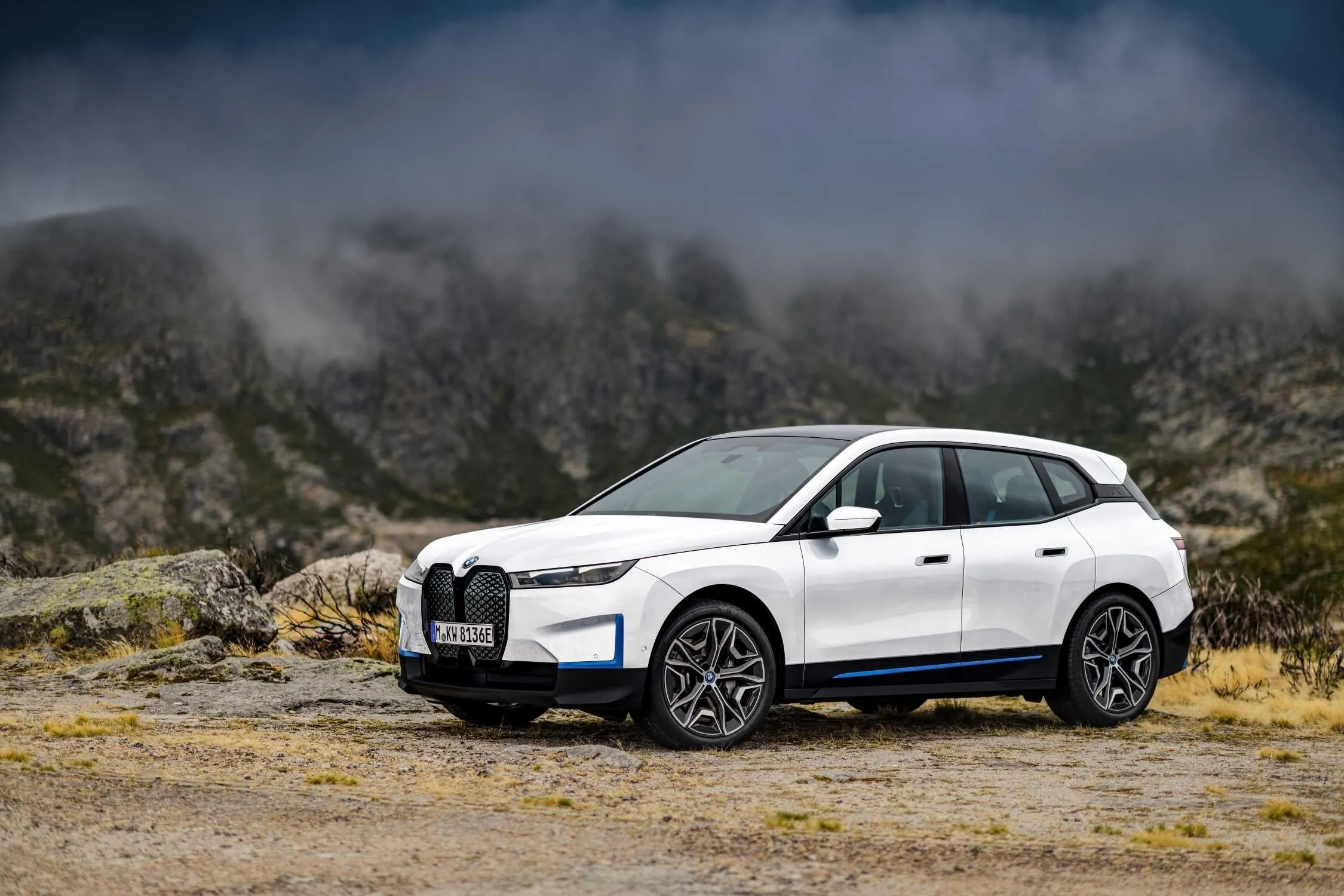 Bmw White Suv Parked on Rocky Terrain with Mountains