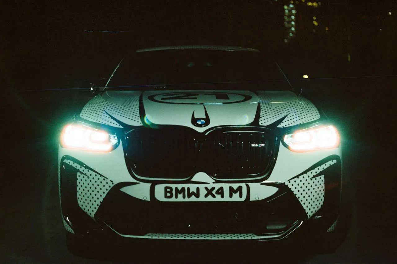 Bmw with Glowing Headlights Driving at Night in City