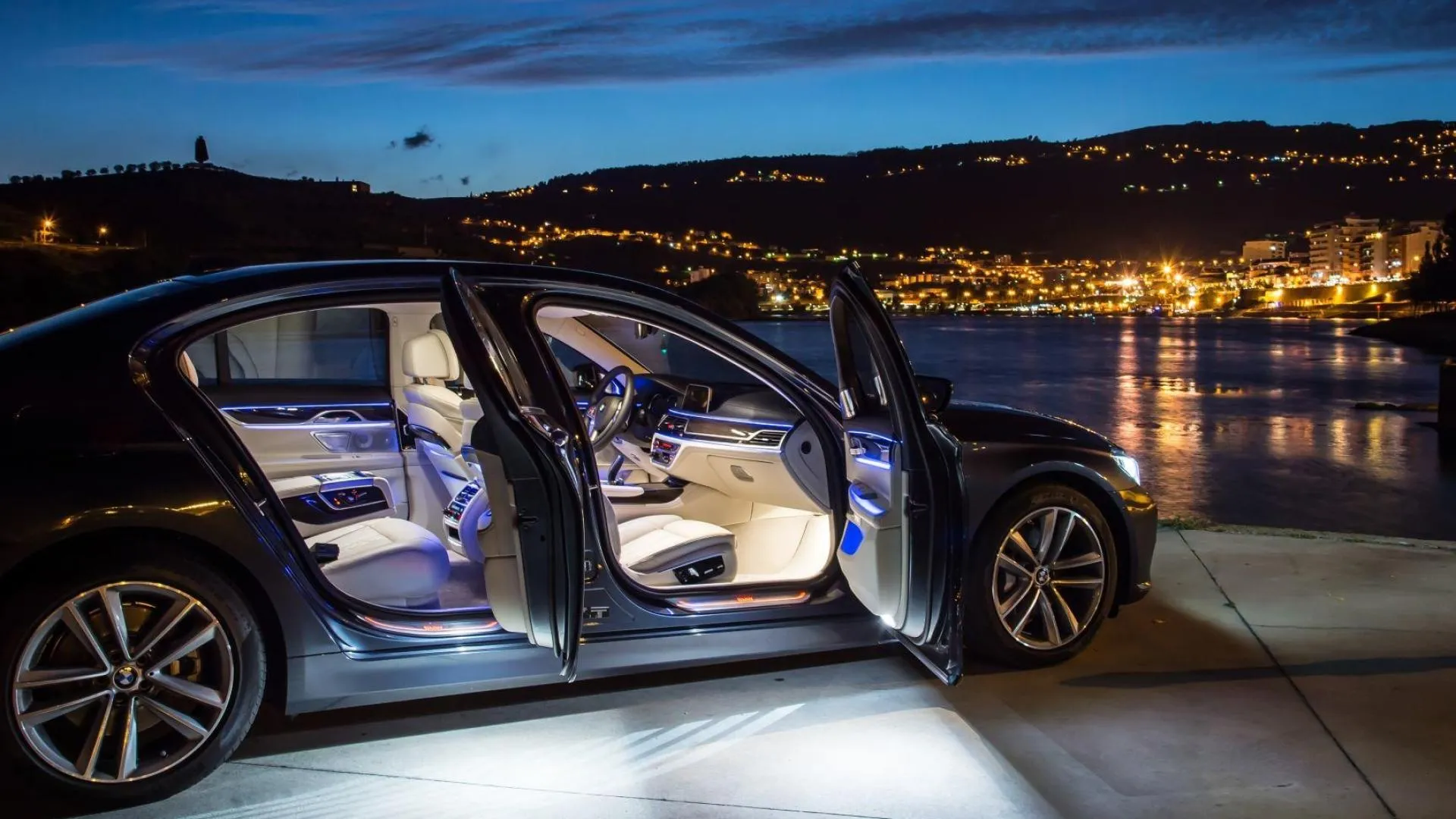 Bmw with Open Doors in a Cityscape at Night with Lights